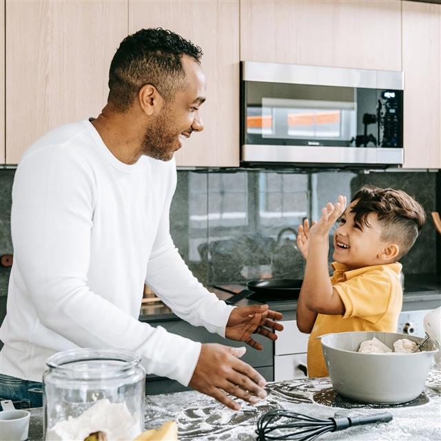 A man and a child in a kitchen